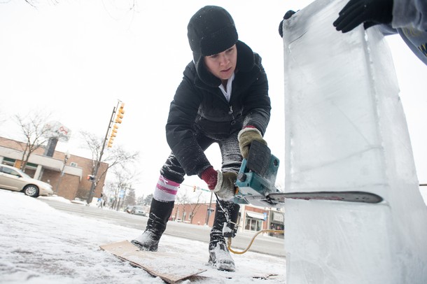 Washtenaw County Community College Culinary student Katie makes a sown man out of ice using a chainsaw during Saline's Winterfest Saturday Jan. 26th.Courtney Sacco I AnnArbor.com 